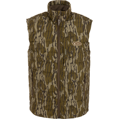 MST Synthetic Down Pack Vest featuring a camouflage design, horizontal baffle, zipper closure, and adjustable drawcord waist, suitable for layering in hunting or outdoor activities.