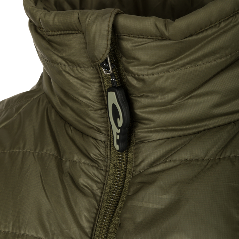 Synthetic Down Pac-Vest: A close-up of a jacket with a black and white logo and zipper. Stay dry and protected with this 100% polyester shell, water-repellent finish, and drawcord waist. Safe storage with internal chest pocket and side slash pockets. Stay outdoors!