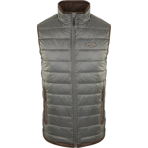 A silver-colored durable Synthetic Double Down Vest by Drake Waterfowl, featuring a horizontal baffle design, suede accents, and reverse coil zippers for outdoor warmth and style.