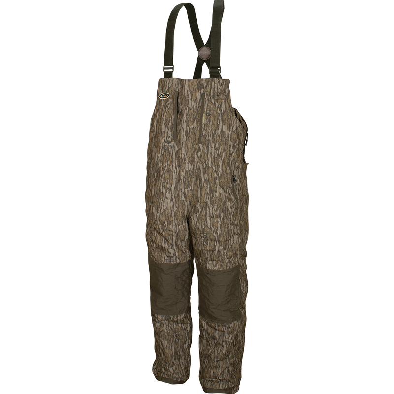 LST Insulated Bib 2.0: Camouflage overalls with straps, fleece-lined hand warmer pockets, and full-length zippers on each side.