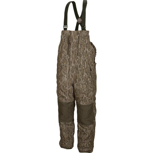 LST Insulated Bib 2.0: Camouflage overalls with straps, fleece-lined hand warmer pockets, and full-length zippers on each side.