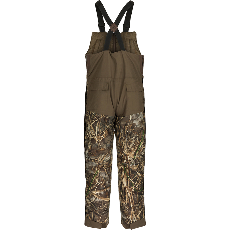 A pair of LST Insulated Bib 2.0 with full-length zippers on each side for easy removal. Features include hand warmer pockets and reinforced knees.