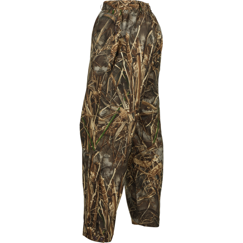 A waterproof and breathable camouflage pants for hunters. Designed to be worn over base layers, jeans, or other pants for protection against the elements. Features an elastic waist, zippered pockets, and ankle-to-knee zippers for easy on/off. Perfectly pairs with the EST Heat-Escape Full Zip or 1/4 for a complete lightweight rain gear set.