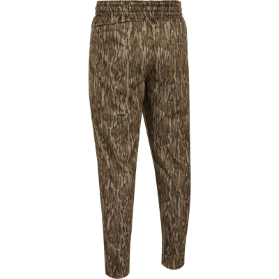 MST Waterfowl Under-Wader Jogger, featuring a camouflage pattern, tapered legs, front slash pockets, and Magnattach™ closure rear pockets, ideal for wearing under waders or lounging.