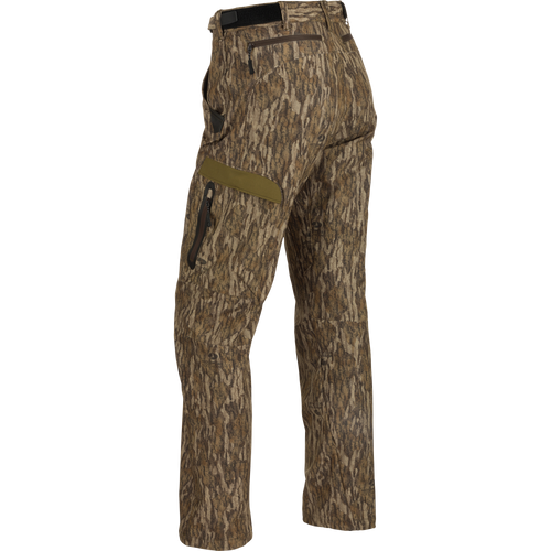 A pair of lightweight, versatile Youth EST Camo Stretch Tech Pants made from 100% polyester. Features include adjustable hook & loop waistband, multiple pockets, zippered fly, and elastic ankle cinch cord. Perfect for hunting and outdoor activities.