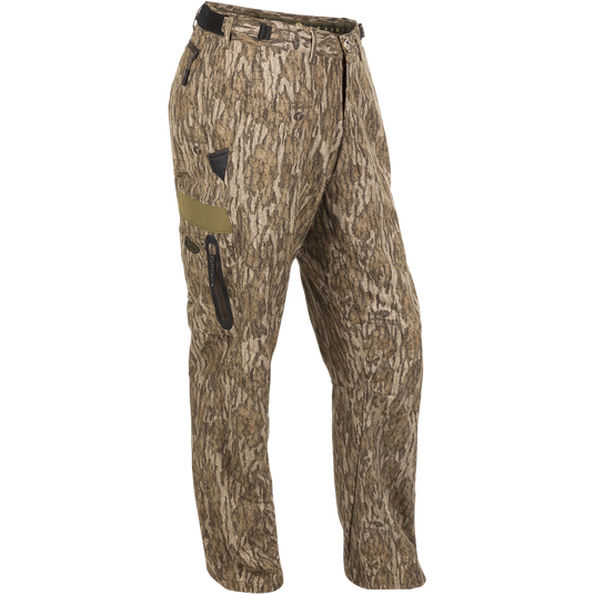 A versatile pair of lightweight Youth EST Camo Stretch Tech Pants made from 100% polyester. Features adjustable waistband, multiple pockets, and elastic ankle cinch cord. Perfect for hunting and outdoor activities.