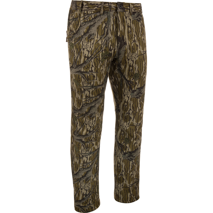 MST Ultimate Wader Pants in woodland camo, showcasing cargo style with adjustable ankles, ideal for hunting; features include zippered pockets and articulated knees for mobility.