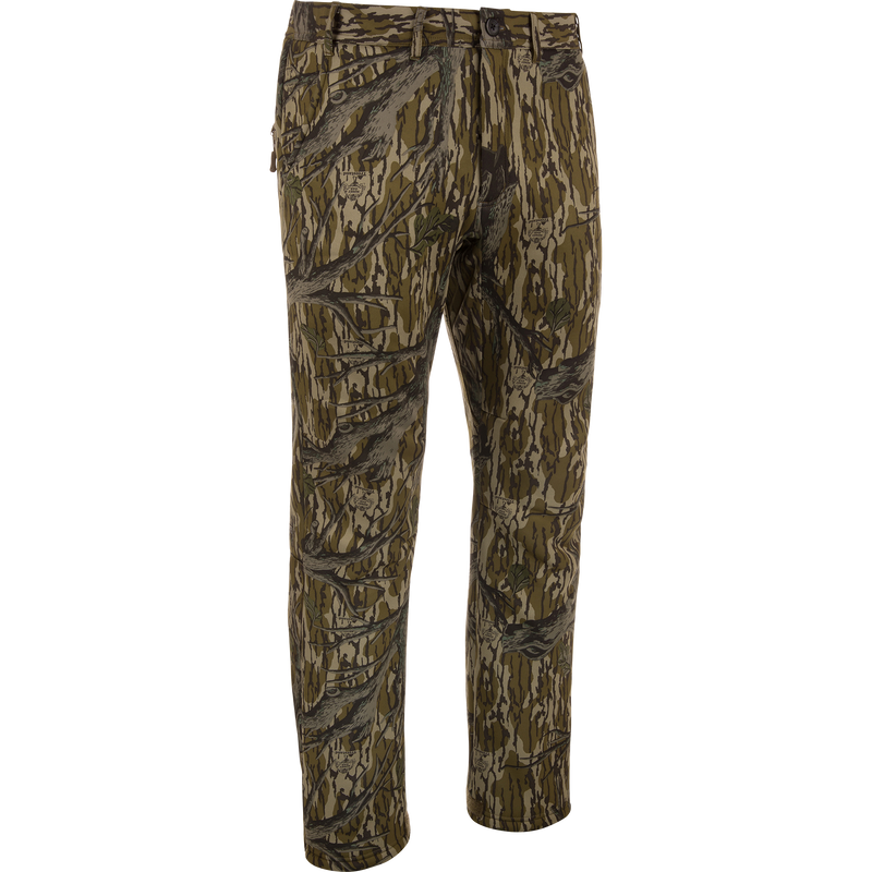 MST Ultimate Wader Pants in woodland camo, showcasing cargo style with adjustable ankles, ideal for hunting; features include zippered pockets and articulated knees for mobility.