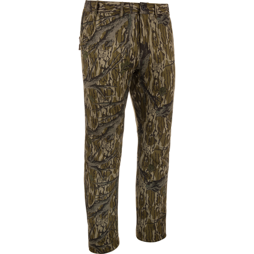 MST Ultimate Wader Pants in woodland camo, showcasing cargo style with adjustable ankles, ideal for hunting; features include zippered pockets and articulated knees for mobility.