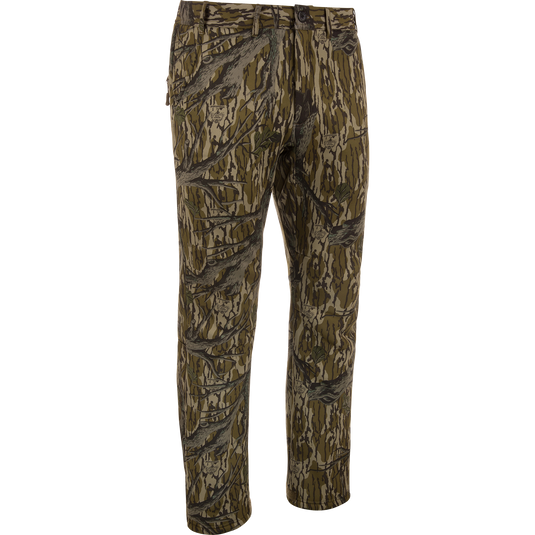 MST Ultimate Wader Pants in woodland camo, showcasing cargo style with adjustable ankles, ideal for hunting; features include zippered pockets and articulated knees for mobility.
