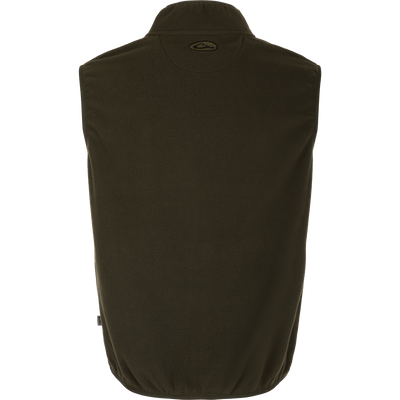 A close-up of the Camp Fleece Vest, a lightweight and breathable layering piece for Spring or Fall outfits. Made of 100% polyester micro-fleece with moisture-wicking properties. Features include anti-pill treatment, vertical Magnattach™ pocket, and lower zippered hand warmer pockets. Perfect for camping or pairing with Drake outerwear.