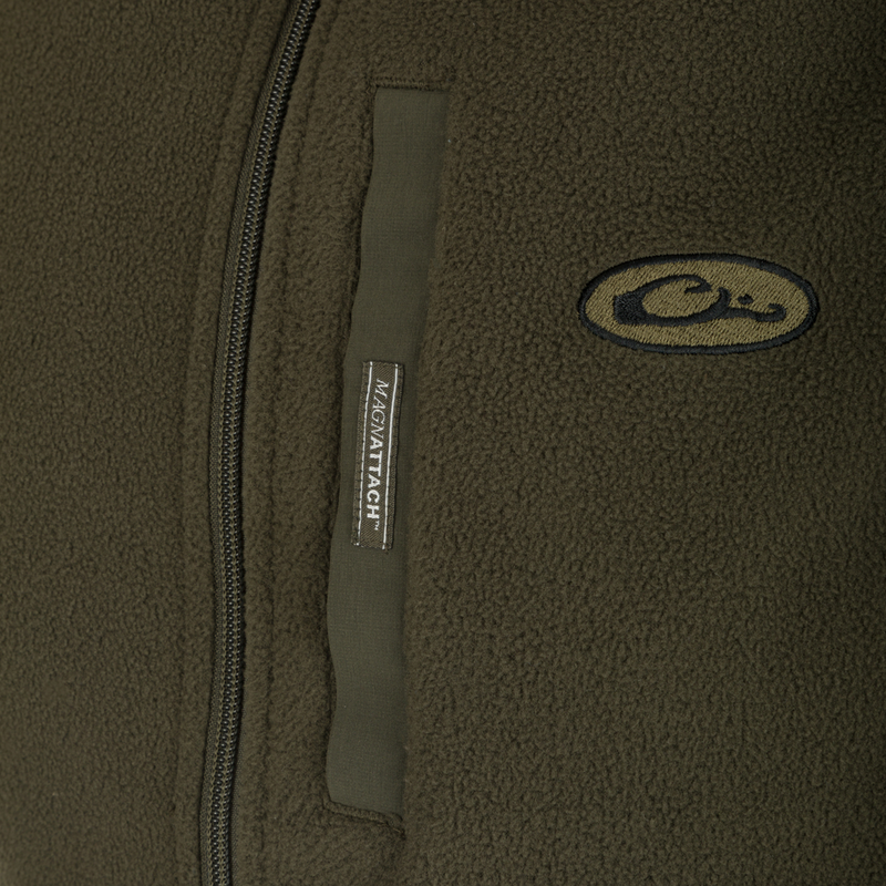 A close-up of the Camp Fleece Vest, showcasing its label and logo. Perfect for layering under outerwear or wearing on its own.