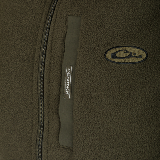 A close-up of the Camp Fleece Vest, showcasing its label and logo. Perfect for layering under outerwear or wearing on its own.