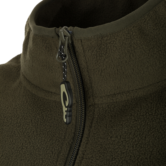 Camp Fleece Vest: Close-up of jacket zipper, featuring vertical Magnattach™ pocket and lower zippered hand warmer pockets. Lightweight, breathable, and moisture-wicking 100% polyester micro-fleece. Ideal for layering in Spring or Fall outfits.