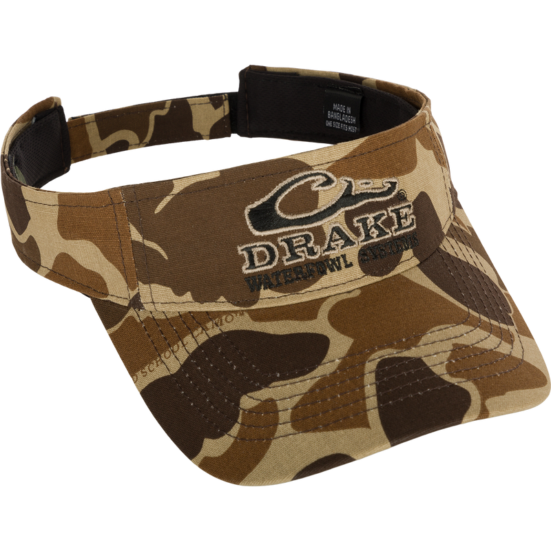 Drake Logo Visor with camouflage pattern and embroidered Drake Waterfowl Systems logo on the front. Velcro back closure. Made of 100% cotton (solid colors) and 100% polyester (camo colors). Lightly structured front panels. One size fits most.