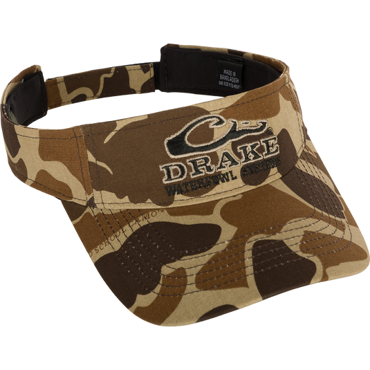 Drake Logo Visor with camouflage pattern and embroidered Drake Waterfowl Systems logo on the front. Velcro back closure. Made of 100% cotton (solid colors) and 100% polyester (camo colors). Lightly structured front panels. One size fits most.