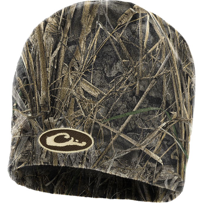 A close-up of a Windproof Fleece Stocking Cap - Realtree, featuring a camouflage pattern and logo. This cap is designed to be worn over the ears or over a hat for maximum protection and heat retention. Made of 100% polyester micro-fleece, it also has a windproof laminate and is water-resistant. Perfect for hunting and outdoor activities.