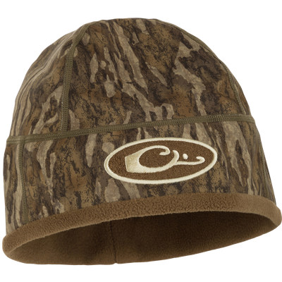 MST Windstopper Beanie featuring camouflage design and logo, crafted for warmth and wind resistance, fitting over ears for added protection.