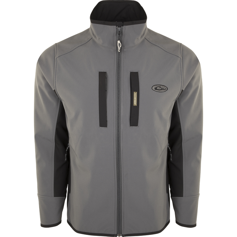A Windproof Tech Jacket with a stylish two-tone design, perfect for cool Fall days and nights. Features include vertical and chest pockets with zipper closures, side stretch panels, and a drawstring waist. Made with a windproof laminate and check fleece backing.