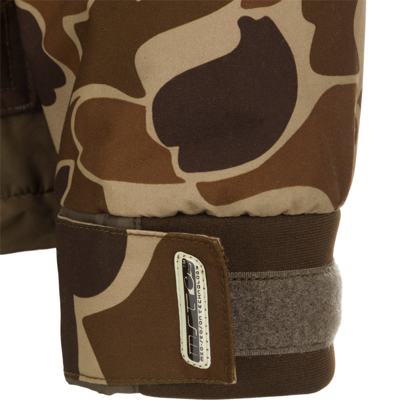 Close-up of MST Waterproof Fleece-Lined Quarter Zip Jacket's camo-print cuff with Velcro strap for wrist adjustment, featuring a branded tag on the tab.