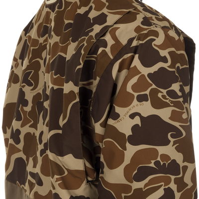Close-up of the MST Waterproof Fleece-Lined Quarter Zip Jacket in old school camo, showcasing its texture and woven text, ideal for mid-season hunting.
