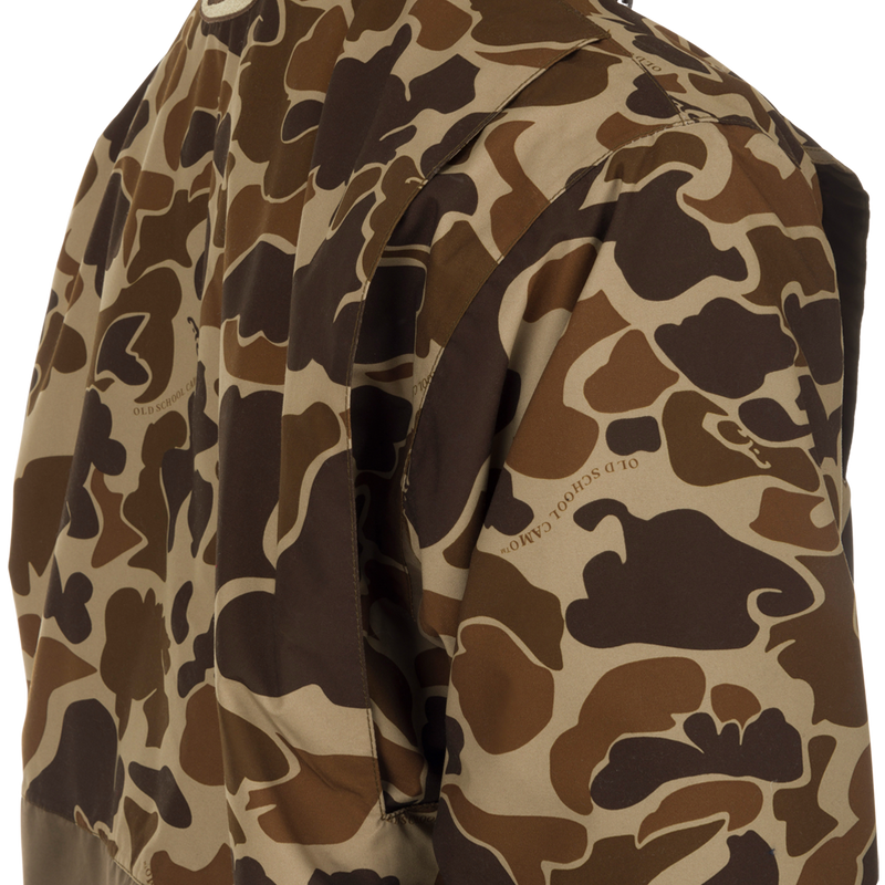 Close-up of the MST Waterproof Fleece-Lined Quarter Zip Jacket in old school camo, showcasing its texture and woven text, ideal for mid-season hunting.