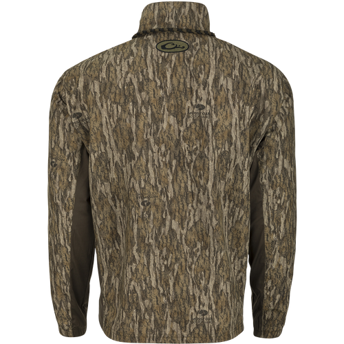 Backside of a  camouflage-patterned EST 1/4 Zip Pullover Shirt by Drake Waterfowl. Features a Magnattach™ pocket, water-resistant shell, breathable sides, and elastic cuffs for hunting and training.