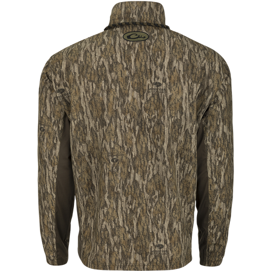 Backside of a  camouflage-patterned EST 1/4 Zip Pullover Shirt by Drake Waterfowl. Features a Magnattach™ pocket, water-resistant shell, breathable sides, and elastic cuffs for hunting and training.