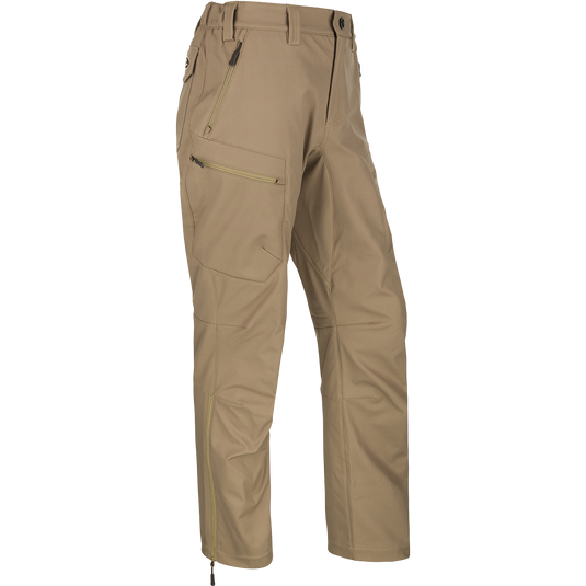 MST Softshell Waterfowler Pants - Realtree, a pair of tan pants with zippers and secure pockets. Versatile and comfortable hunting pants for mid-season or late-season hunts. Perfect for layering over your regular pants for added warmth and protection.