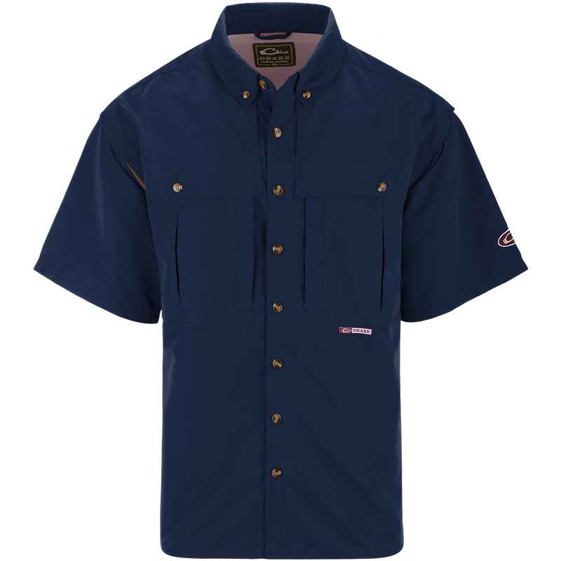 A blue short sleeved shirt with a seven button design, front and back ventilation, and multiple chest pockets. Perfect for outdoor activities like shooting or fishing. Made with wrinkle-resistant EasyCare™ fabric and 100% polyester twill fabric.