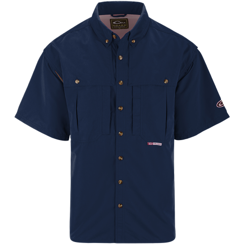 A blue short sleeved shirt with a seven button design, front and back ventilation, and multiple chest pockets. Perfect for outdoor activities like shooting or fishing. Made with wrinkle-resistant EasyCare™ fabric and 100% polyester twill fabric.