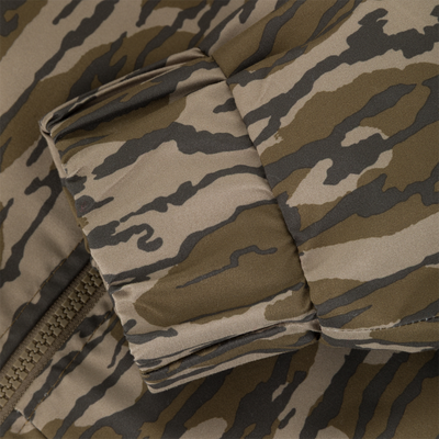 Close-up of an MST Waterproof Full Zip Jacket w/ Hood sleeve cuff with a zippered closure and a brown and olive green camouflage pattern.