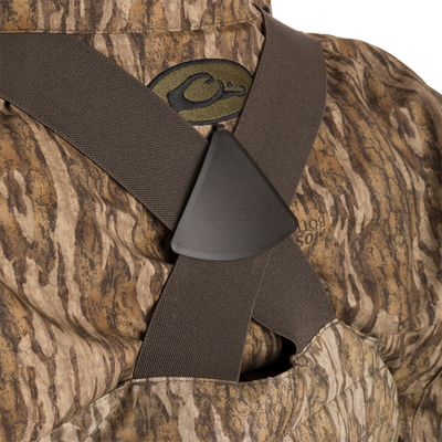 Close-up of the Women’s Insulated Guardian Elite Vanguard Breathable Waders, showing camouflage pattern, reinforced seams, and front cargo pouch.