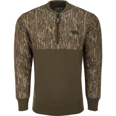 A close-up of the Camo 1/4 Zip Wool Sweater, featuring a knitted wool lower and a polyester upper treated with DWR for weather protection. The sweater has a quarter zip for ventilation and comfort.