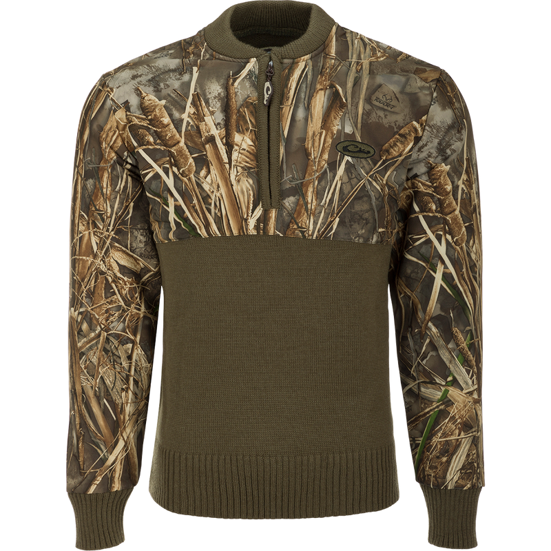 A camo 1/4 zip wool sweater with a polyester upper treated with DWR for protection against the elements. The 650-gram knitted 100% wool lower provides warmth and breathability.