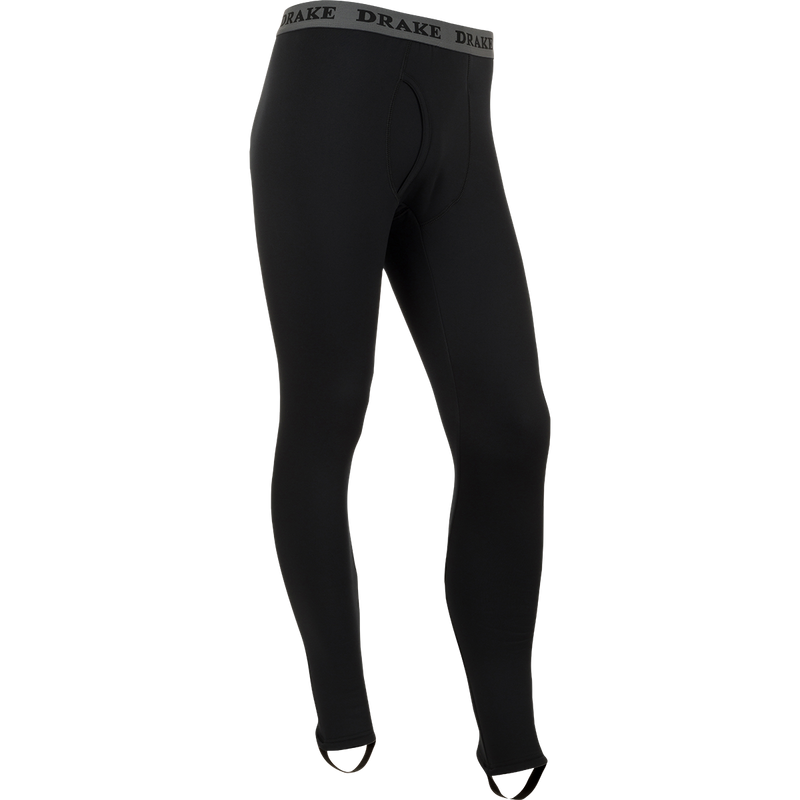 LST Heavyweight Baselayer Pant: Black pants with logo, exceptional stretch, extreme warmth, moisture-wicking, stirrup strap for layering under waders, front fly for convenience. Stay warm and comfortable during active and cold weather activities.