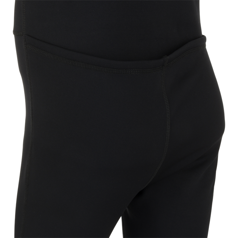 LST Heavyweight Baselayer Union Suit: A close-up of black pants made from Nylon, Polyester, and Spandex. Exceptional stretch, extreme warmth, and moisture-wicking capabilities. Stirrup strap for layering and a front zip and drop seat for quick relief.