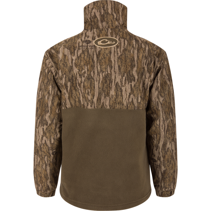 Rear view of the MST Youth Eqwader Quarter Zip Jacket, featuring a bark-style camo upper and olive-brown fleece lower back, designed for waterfowl hunting comfort.
