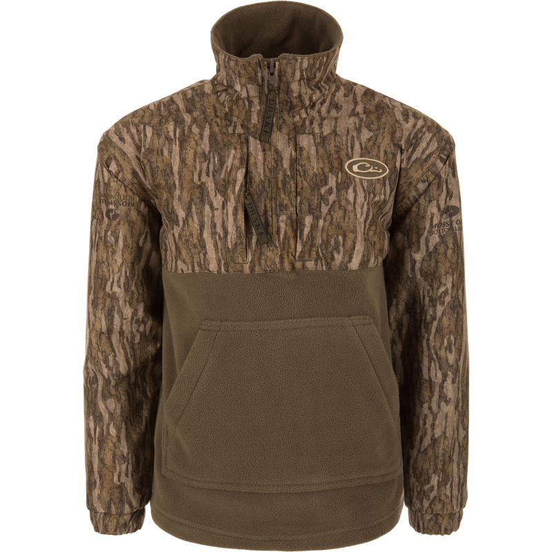 MST Youth Eqwader Quarter Zip Jacket with camo-patterned upper, olive fleece lower, features kangaroo pocket, branded zippers, designed for dual-zone comfort with waterproof and breathable materials.
