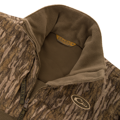 MST Youth Eqwader Full Zip Jacket with camo fleece, half-zip, stand-up collar, and interior mesh lining, featuring Drake branding on collar and zipper pulls.