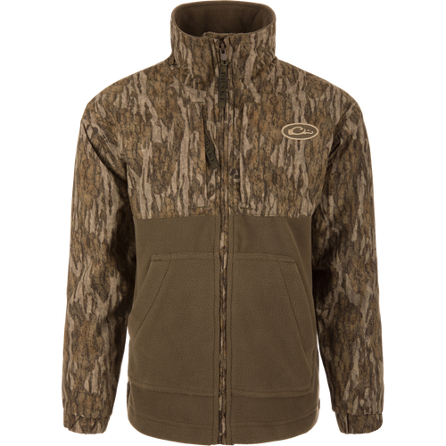 MST Youth Eqwader Full Zip Jacket featuring tree-bark camo print and olive-green fleece, stand-up collar, hand-warmer pockets, and dual-zone waterproof and breathable fabric.