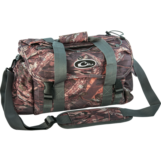 A large camouflage bag with straps, featuring 18 pockets for organizing gear. Waterproof internal compartment and durable HD2™ material. Perfect for hunting and outdoor activities.