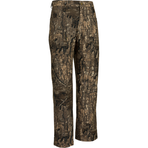 A pair of camouflage pants for women, made with 100% waterproof/windproof/breathable material. Relaxed jean-cut fit with ankle garters and elastic stirrups. Front slash pockets, adjustable waist, and rear zippered pocket. MST Women's Refuge Bonded Fleece Pants - Real Tree Timber.