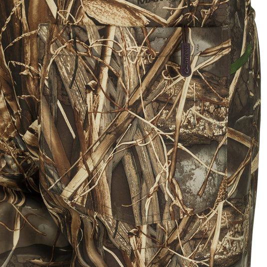 MST Women’s Refuge Bonded Fleece Pants - Realtree: A close-up of the pants' pocket, with adjustable ankle cuffs and elastic stirrups.