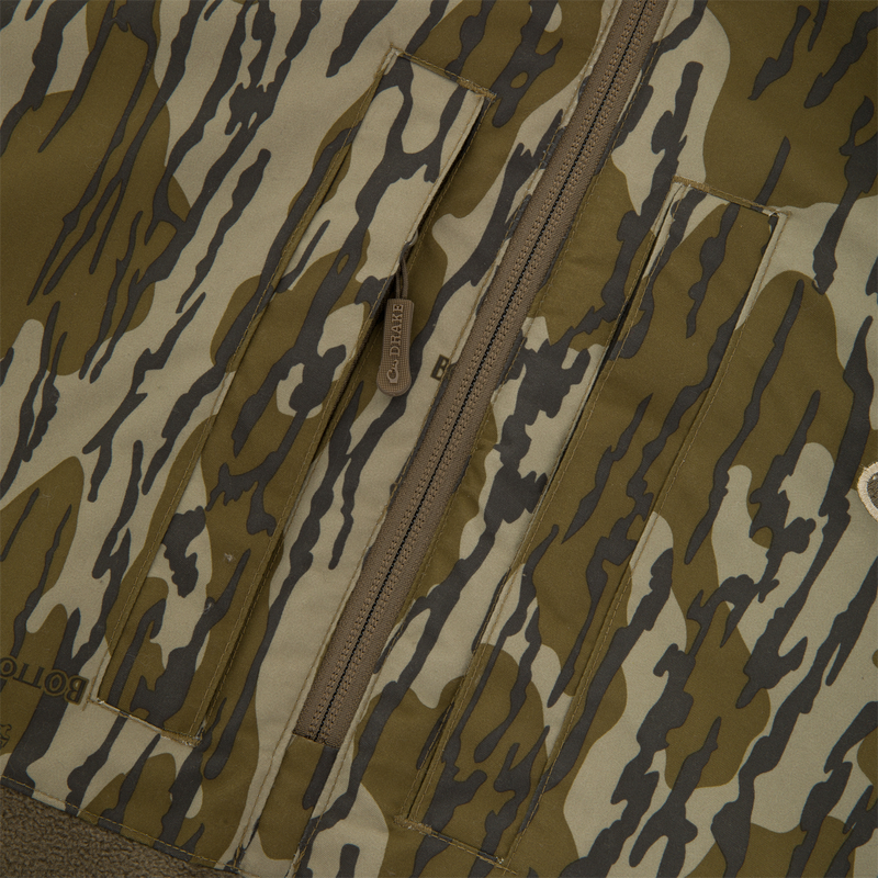 BFCM - MST Camo Eqwader 1/4 Zip Jacket featuring a tiger-stripe pattern with front pocket flaps, central zipper, and patented Eqwader™ technology for enhanced comfort in waterfowl hunting.