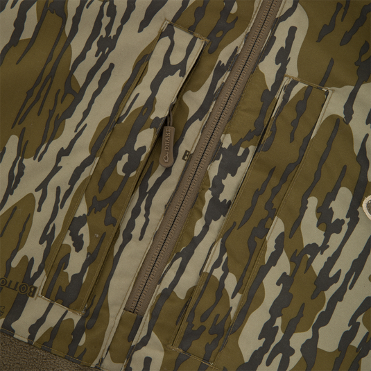 BFCM - MST Camo Eqwader 1/4 Zip Jacket featuring a tiger-stripe pattern with front pocket flaps, central zipper, and patented Eqwader™ technology for enhanced comfort in waterfowl hunting.