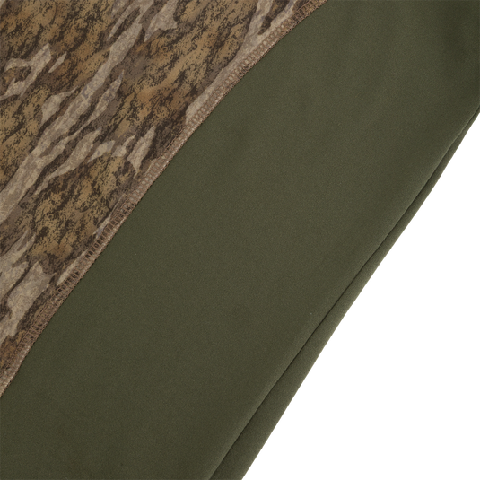 Close-up of a Drake Base Layer Crew Neck featuring a brown camouflage pattern on the upper section and solid olive green fabric on the lower section.