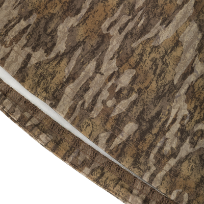 Close-up of the moisture-wicking hem on a brown and tan camouflage Drake Base Layer Crew Neck.