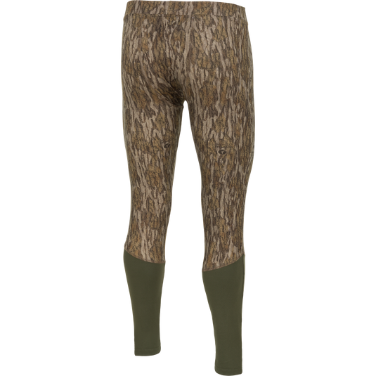 Back view of Drake Base Layer Bottom moisture-wicking camouflage-patterned leggings with solid olive green lower legs.