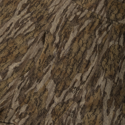 Close-up of moisture-wicking, brown and tan camouflage Drake Base Layer Bottom featuring a vertical seam and a faint Waterfowl brand logo imprint.